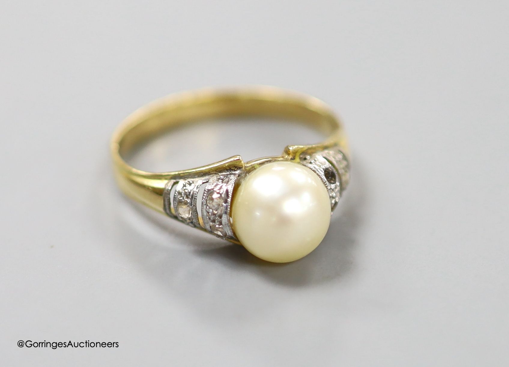 A modern yellow metal, cultured pearl and gem set ring, size O, gross weight 3.3 grams